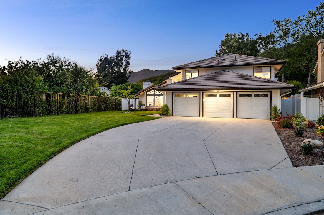Freshly poured residential concrete driveway with clean broom finish